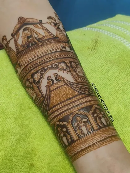 The Doli scene is now part of a full arm design, layered with more patterns and motifs like peacocks and architectural borders.