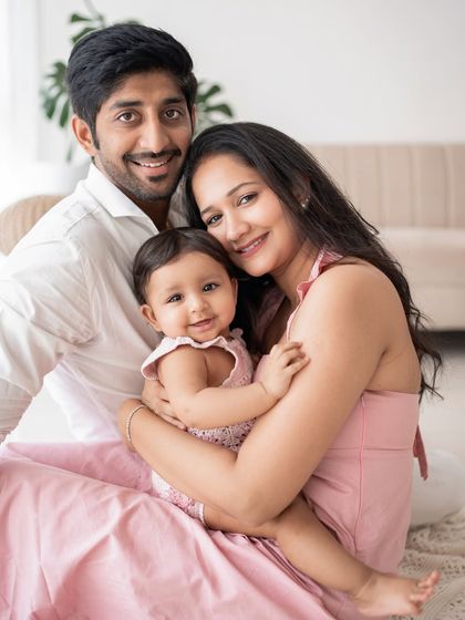 A beautiful family portrait in soft pink tones.