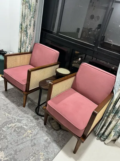 A pair of mid-century armchairs with cane side panels, upholstered in a beautiful rose-pink fabric for a client.