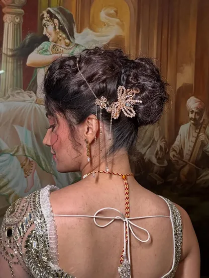 A detailed close-up of the textured bun and the beautiful butterfly hairpiece. I love adding unique accessories to make a hairstyle truly special.