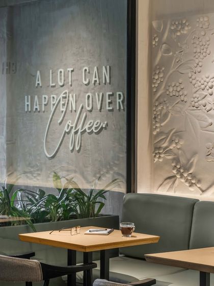 Every detail tells a story. We paired the iconic tagline, "A lot can happen over coffee," with a textured mural honoring coffee's journey, creating a space that is modern yet rooted in the brand's heritage.