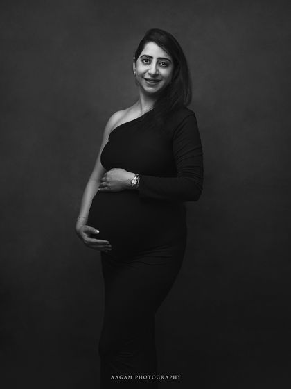 A simple and elegant black and white portrait, her happy expression and the classic one-shoulder gown create a timeless look.