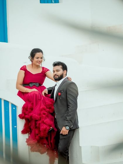 A sweet and casual pre-wedding portrait. The red ruffled gown adds a touch of glamour to this relaxed and happy moment.