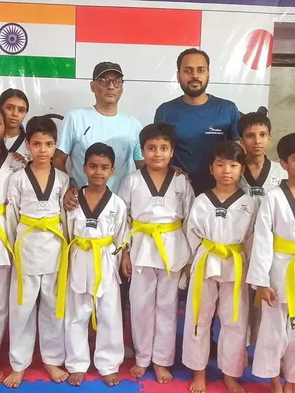 Our new yellow belts, proud and excited to have passed their first major test in Taekwondo.