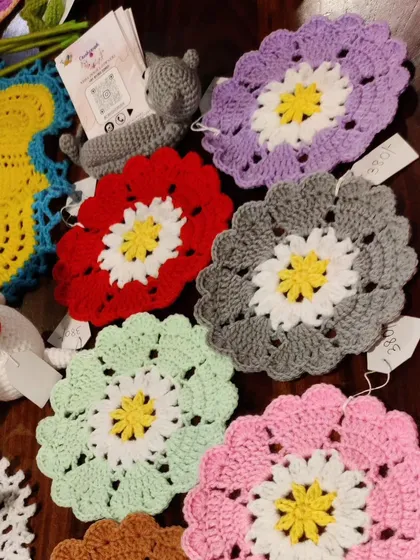 A collection of my colorful flower-shaped coasters as seen at one of my exhibitions. They are perfect for adding a pop of color to your coffee table.