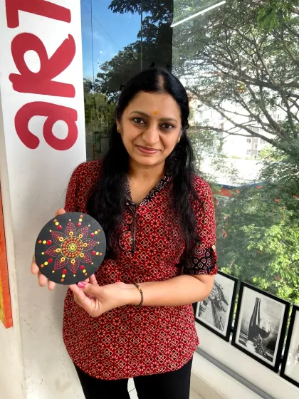 A participant with her finished dot mandala. The careful placement of each dot creates a beautiful and harmonious design.