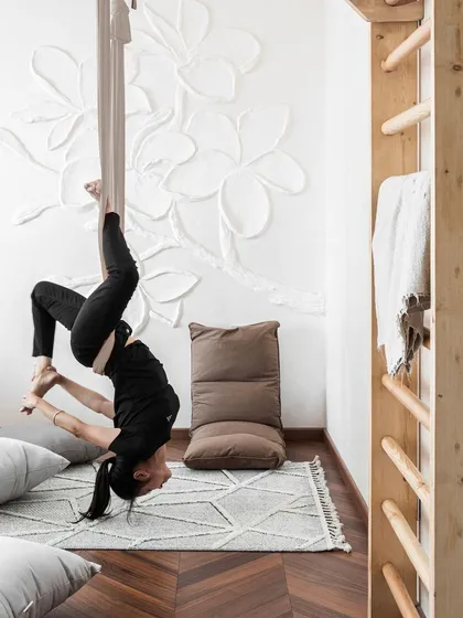 A home must be a reflection of how you live. For a client who is a dedicated yoga practitioner, I designed this serene space with custom wooden wall bars for daily stretches and a calming, minimalist aesthetic, turning her room into a true personal sanctuary.
