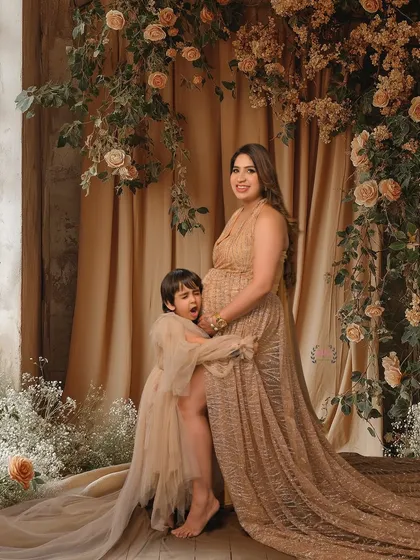 A candid and playful moment between a mother and her son during her maternity shoot. These genuine interactions make for the best memories.