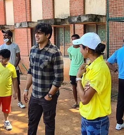 Neeraj Chopra interacting with my players and coaching staff on the court, creating an unforgettable experience for everyone.