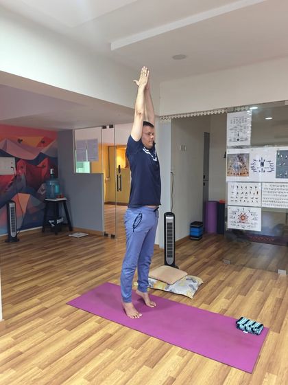 In Tadasana, the arms reach up, lengthening the sides of the body. This action, combined with grounded feet, teaches the principle of finding both stability and lightness.