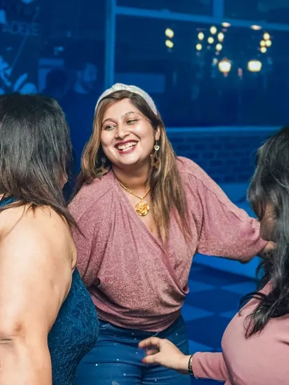A candid moment of friends enjoying the music and each other's company on the dance floor.