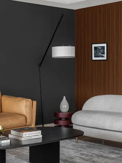 We used a bold, dark feature wall in Apartment 1600 to create a dramatic and intimate lounge area. The rich wood paneling and tan leather sofa add warmth and texture, resulting in a sophisticated space designed for hosting and relaxation.
