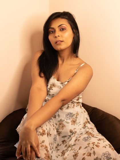 A thoughtful and composed portrait. The simple setting and neutral tones keep the focus on her expression.