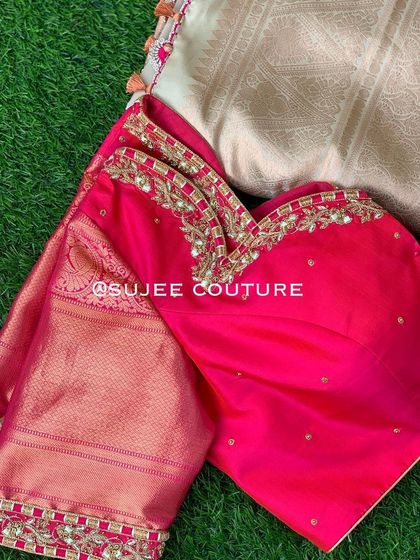 A flat-lay view of the rani pink blouse, showing its sweetheart neckline and the matching Kanchipuram silk fabric of the saree it was designed for.