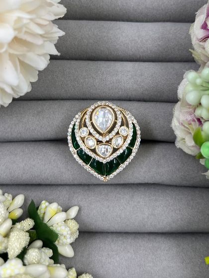 Our leaf-shaped adjustable rings, featuring a large central Moissanite stone surrounded by American Diamonds. These are available in green, red, and pink Meenakari finishes.