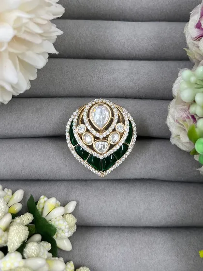 A close-up of the green leaf-shaped ring.