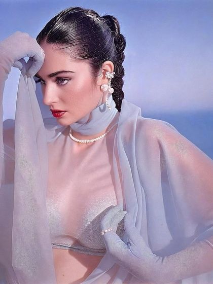 Kavya Trehan in a thoughtful pose, wrapped in translucent fabric. The cool blue tones and her soft expression create a serene and otherworldly mood.