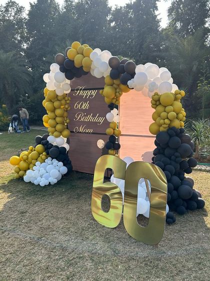 Another angle of the outdoor 60th birthday setup, showing the large golden marquee numbers.