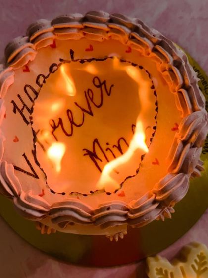 The moment of reveal on the burn-away cake. The top layer burns away to show the secret message underneath.
