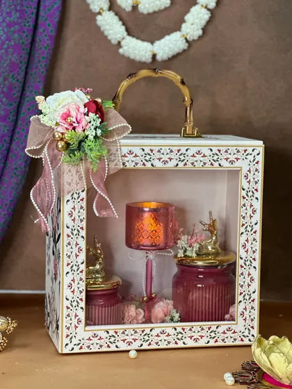 Another angle of our popular window box hamper. The floral arrangement on top adds a touch of softness, while the lit candle inside creates a warm, festive glow perfect for Diwali gifting.