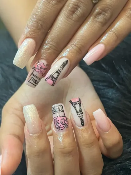 Take a trip to Paris with this themed nail art. This set features hand-painted Eiffel Towers and perfume bottles on a shimmery pink base.