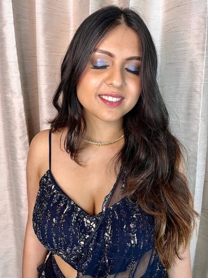 A close-up of the eye makeup, featuring a beautiful wash of blue and silver shimmer. It's a modern and chic take on a smokey eye.