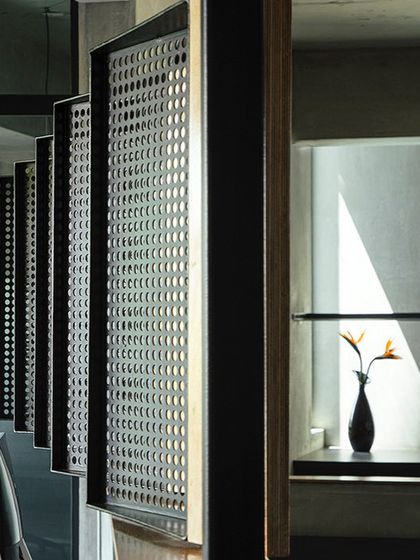 A duplicate of the previous image, this detail shot of the pivoted louvers in our studio highlights the texture and precision of the custom-fabricated elements that define our workspace.