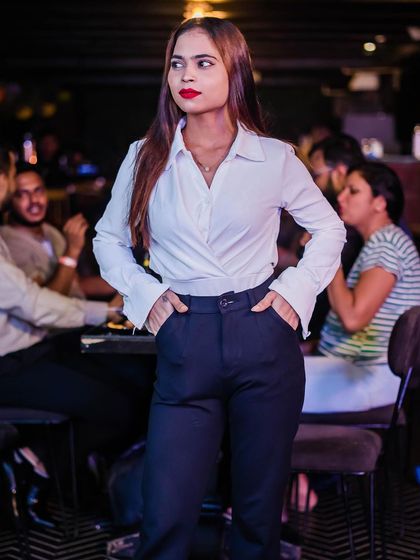 A guest looking stylish in a white top and blue trousers.