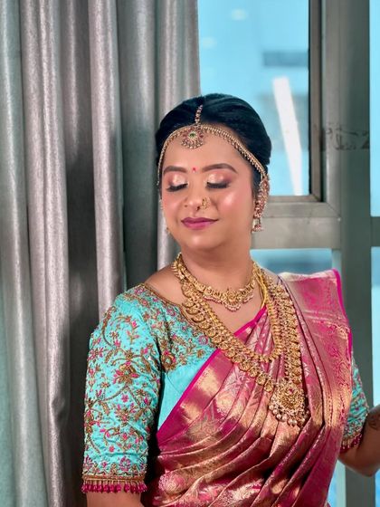 A serene portrait of the bride, showcasing the flawless makeup and the neat, traditional updo I created to complement her Kanjivaram saree.