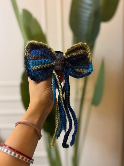 This tassel bow in shades of blue and gold is a more subtle yet equally beautiful option for your hair.