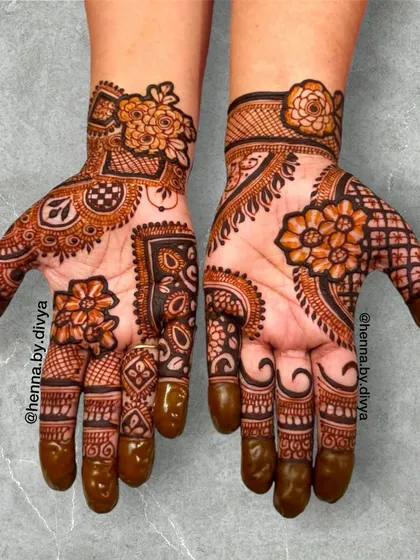This is a full-palm design that combines intricate floral work with classic paisley and geometric elements. It's a rich, dense pattern that is perfect for close family members or anyone wanting a statement look for a festival or wedding.