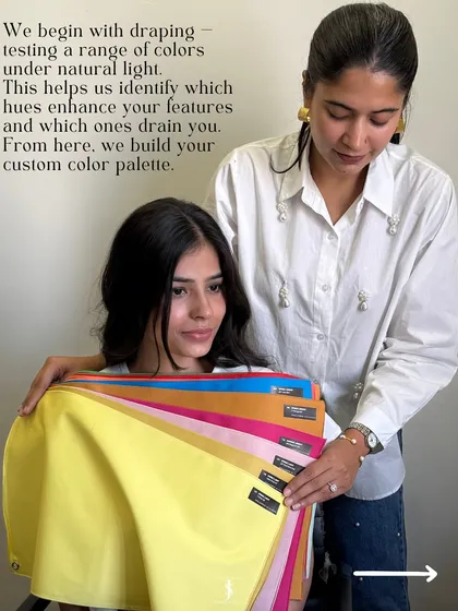 As we continue the draping process, we test a wide spectrum of colors under natural light. Holding up a fan of drapes like this helps us quickly identify which color family, whether it's bright and cool or soft and warm, enhances your natural features.