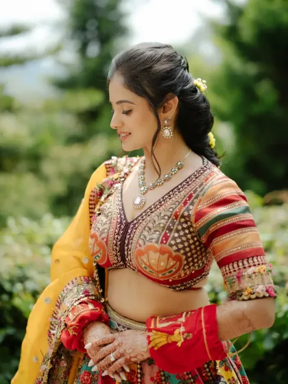 A stunning close-up of the bride during her Haldi. Her colorful lehenga, intricate jewelry, and joyful expression make for a perfect bridal portrait.