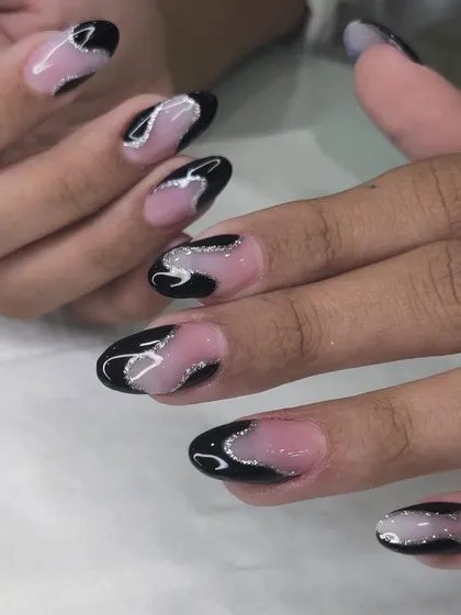 A chic and edgy design with black and silver glitter swirls on a nude base.