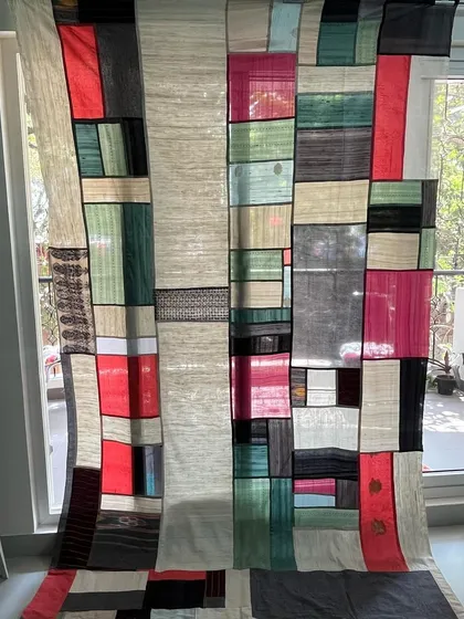 Beyond blankets, we create functional art for your home. This is a Pojagi-style room divider, crafted from translucent sarees and dhotis to create a stunning stained-glass effect that plays with light.