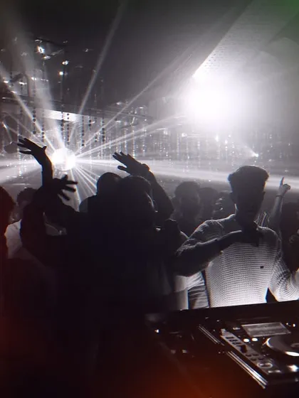 The crowd's energy is everything. This photo shows the audience with their hands up, completely connected to the music and the moment.