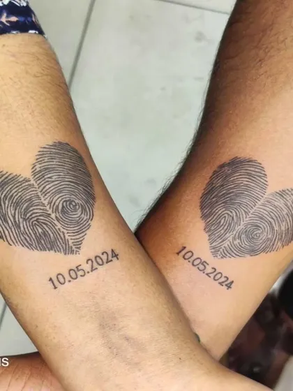For a truly personal couple's tattoo, we used the clients' actual fingerprints to form two hearts. It's a unique way to show your connection, and I love working on these 'swalpa different' ideas that are special to you.