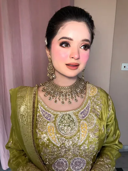 Another angle, capturing the soft light and the intricate details of her outfit and jewelry.