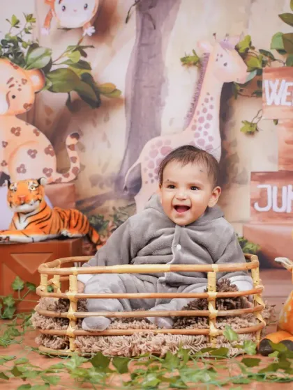 Welcome to the jungle! This little one is having a wild time in our jungle safari setup, complete with friendly animal props.