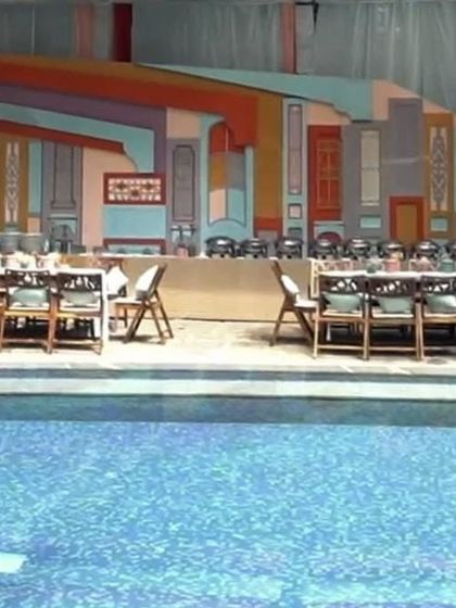 A closer view of the poolside food station, where the backdrop of colorful, layered panels created a festive and unique atmosphere.