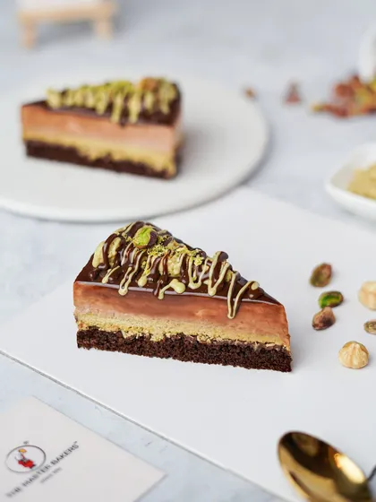 A slice of our Hazelnut Kunafa Pastry is pure decadence. It features layers of rich chocolate and nutty hazelnut, with the added crunch of kunafa for a multi-layered texture and flavor experience.