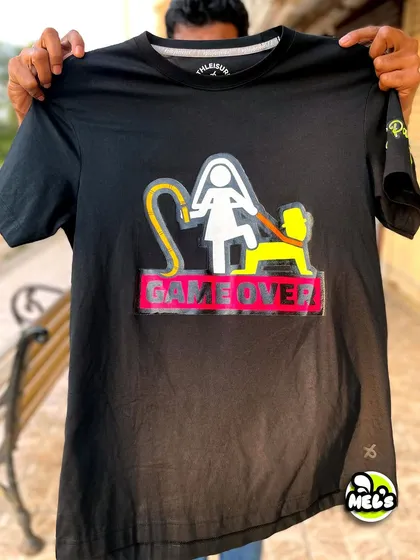 Custom apparel is a big part of what we do. This 'Game Over' T-shirt was hand-painted with glow-in-the-dark neon paints for a bachelor party, showing how we can create fun, personalized gear for any event.