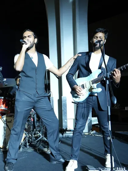 Our lead singer Aryaman and guitarist Joshua interacting on stage during the Budweiser India event. The chemistry between our band members is a huge part of our live energy.