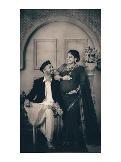 A tender moment of connection between the couple during their traditional studio session. Her hand on his shoulder, their shared gaze speaks volumes about their partnership on this journey to parenthood.