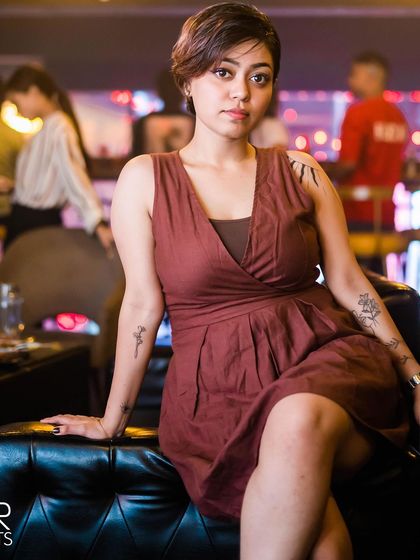 A guest with tattoos, sitting in the lounge area.