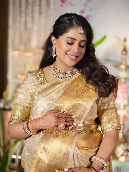 This is the look of timeless grace. For her Godh Bharai, we chose a soft glam makeup to complement her magnificent gold saree. I focused on creating luminous skin, warm shimmery eyes, and a soft lip, enhancing her natural radiance for this sacred celebration.