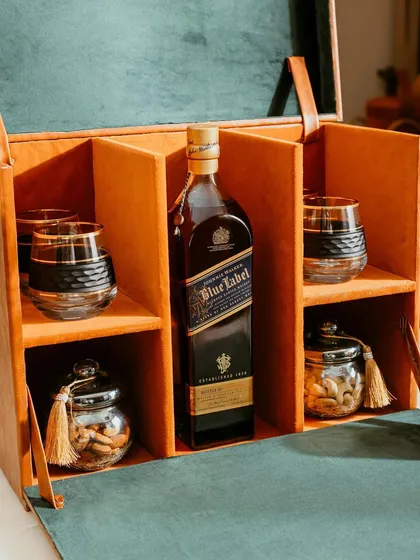 For the connoisseur, we present our luxury whiskey hamper. It features a premium bottle of your choice, crystal glasses, and gourmet nuts, all housed in a sophisticated, handcrafted leatherette box.