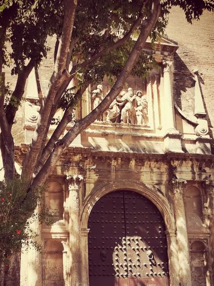 The intricate details of a historic doorway in Sevilla. The city's rich history is etched into its architecture, providing a powerful backdrop for our deep dive into the equally rich history of the flamenco art form.