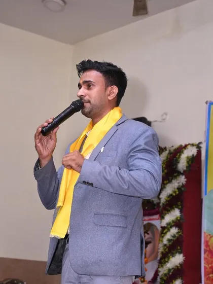 Addressing the audience at the cultural event, grateful for the opportunity to share my magic.