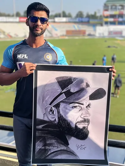 Here I am at a cricket ground holding my large-format pencil portrait of Virat Kohli. It's an incredible feeling to bring my art to the very place where these legends make history.
